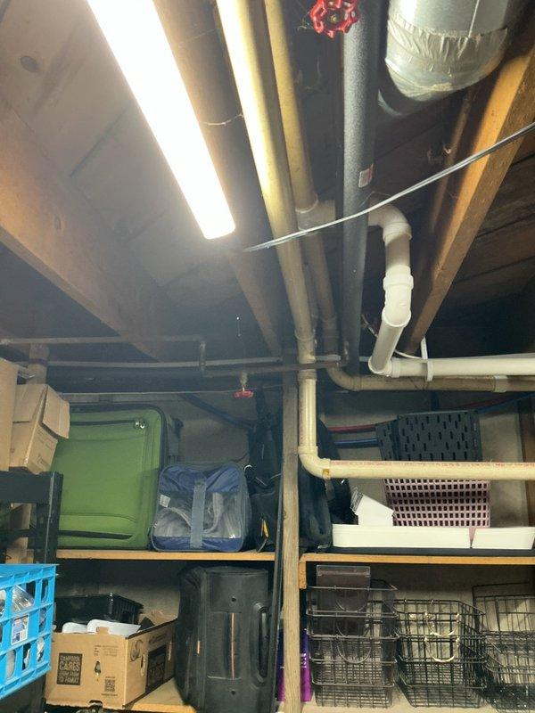 Responded to septic system service call where customer reported sewage odors and drainage issues from toilet basin. Upon inspection, identified problems with the vent piping system and septic pump operation. Documented existing PVC drainage configuration and mechanical room layout to prepare comprehensive estimate for necessary drain line and vent line re-piping work.