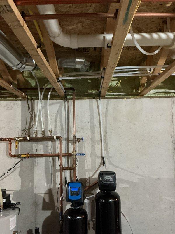 Installed new sewage ejector pump with high water alarm system to alert homeowner of potential backups or flooding in the septic system. Additional work included installation of black RO faucet and re-piping the drain from new water treatment system to standpipe, completing comprehensive plumbing system upgrades in basement mechanical area. Total service time: 3-4 hours.