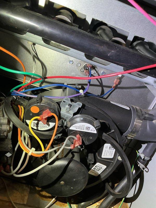 Diagnosed 8-year-old Amana furnace with no heat issue. Inspection revealed a pressure switch stuck in open position. Attempted to free the switch without success, requiring complete replacement of the pressure switch to restore proper furnace operation.