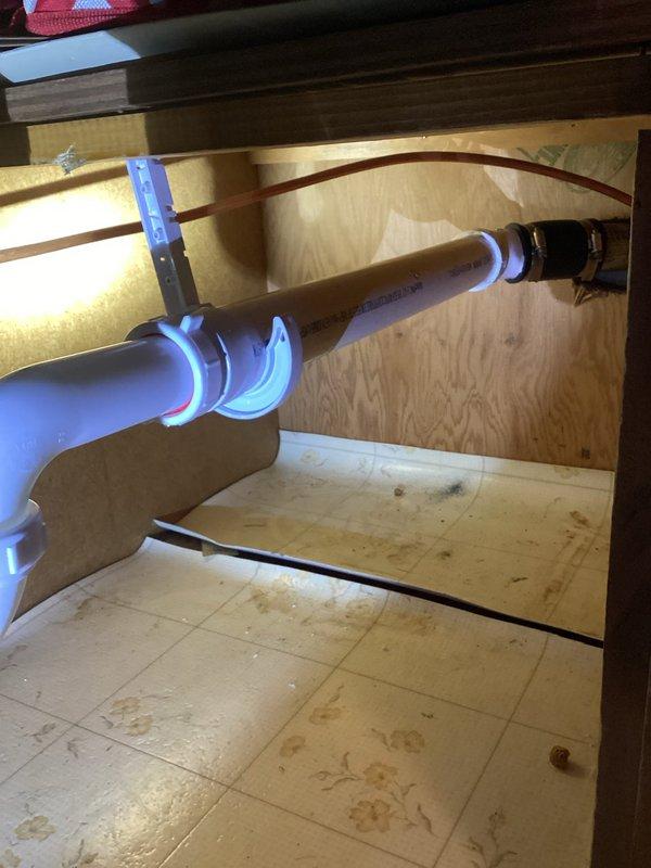 Responded to service call for a kitchen sink leak. Diagnosed horizontal drain pipe with complete clog. Removed affected section, replaced with new PVC piping and verified proper drainage function with successful flow test.