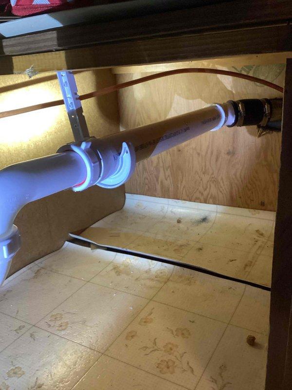 Responded to service call for a kitchen sink leak. Diagnosed horizontal drain pipe with complete clog. Removed affected section, replaced with new PVC piping and verified proper drainage function with successful flow test.