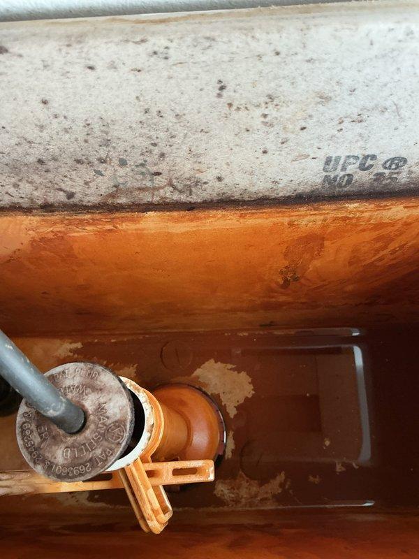 Responded to service call for two plumbing issues: replaced corroded washing machine valves and installed a new toilet. The original toilet (approximately 40 years old) had stopped running properly and required water shut-off. Completed installation of new laundry valves to address deterioration and corrosion observed in the recessed water valve access panel. Customer advised about clearance issue with toilet tank lid due to overhead shelf.