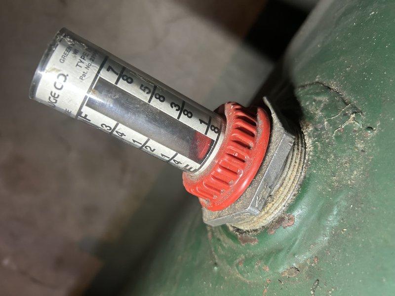 Performed standard oil furnace tune-up including nozzle replacement and filter change. Inspected capacitor and found it in working condition. Identified and addressed oil leak at filter housing by replacing filter and gaskets, with no residual leakage observed after repair. Advised customer that oil tank gauge readings appear inaccurate, though customer is aware of current oil levels.