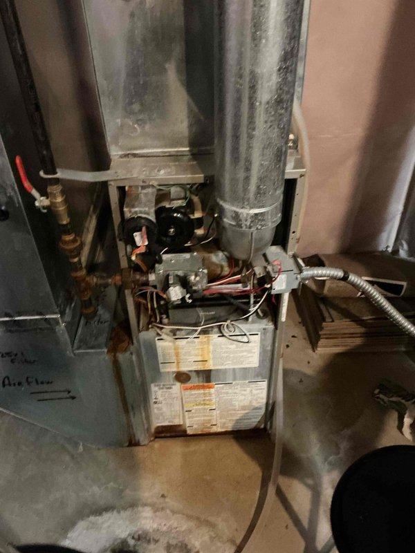 Responded to no-heat call for 19-year-old Carrier furnace. Diagnostic testing revealed seized induced draft motor and extensive water damage from AC affecting multiple components including control board, burners, and blower motor. Replaced induced draft motor to restore immediate heating function and scheduled service advisor for assessment of additional damaged components. Verified proper operation before departure.