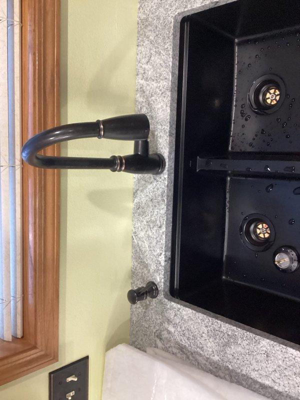 Installed customer-supplied kitchen faucet on existing marble top sink, replacing all undersink plumbing components. Replaced three shut-off valves that were not closing properly and installed new drain piping assembly for dual-basin sink, ensuring proper function of both basins and new fixtures.