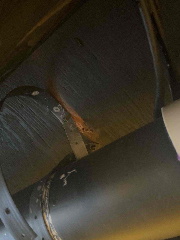 Inspected furnace exhaust system in response to customer complaint of gurgling sounds. Identified water accumulation in the exhaust pipe and inducer assembly. Corrected the issue by draining collected water and adjusting the exhaust pipe pitch to ensure proper condensate flow and prevent future water buildup.