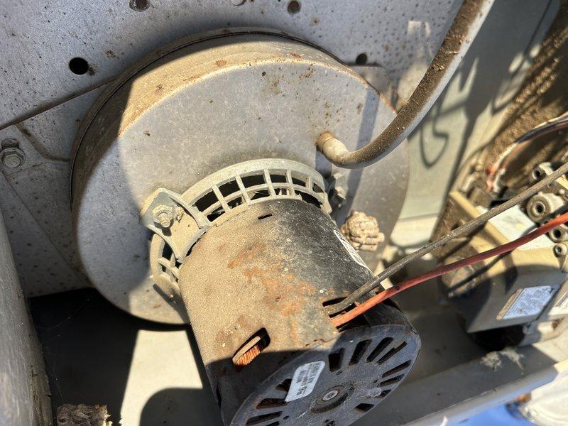 Diagnosed no-heat complaint on 20-year-old commercial rooftop furnace during -10°F conditions. Observed 3-blink error code indicating pressure switch failure and confirmed inducer motor was not operating despite 210V power supply. Inspection revealed aging inducer assembly with significant dust accumulation and corrosion. Recommended inducer motor replacement; estimate provided through parts department.
