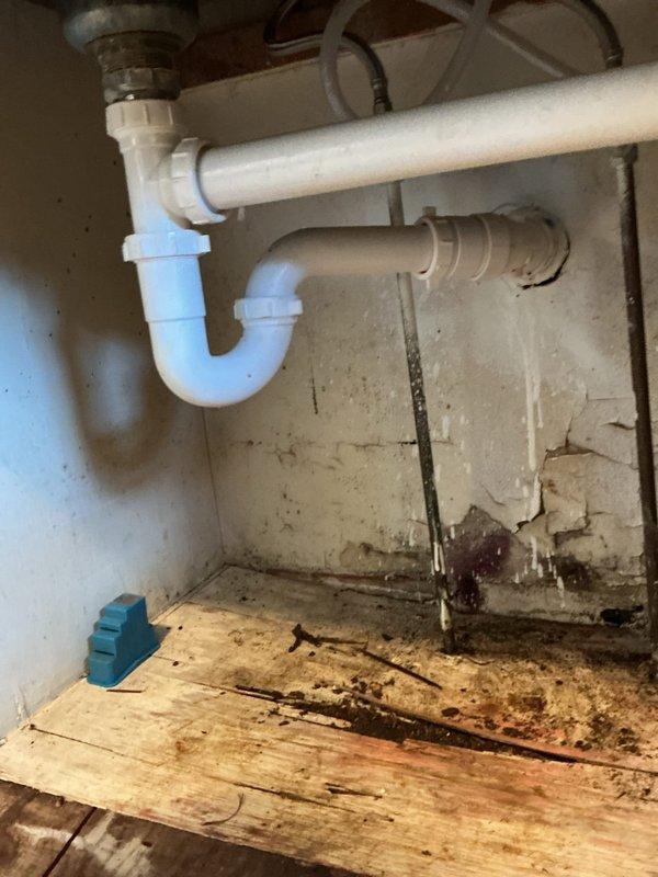 Responded to customer service call for broken drain line under kitchen sink. Upon inspection, found drain pipe snapped off at connection point. Extracted broken nipple from fitting, installed new P-trap assembly, and performed drain snaking to ensure proper flow and functionality. Completed repair successfully, resolving drainage issue and preventing further water damage to cabinet structure.