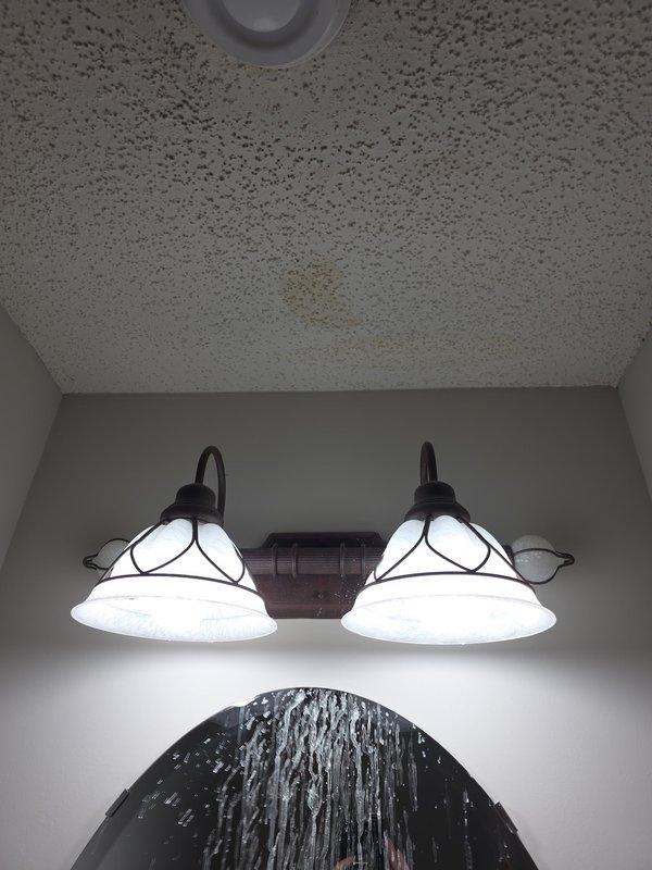 Responded to water stain in powder bathroom ceiling caused by leaking second-floor shower drain. Created access hole in affected ceiling, removed faulty compression-style drain assembly, and installed new two-piece shower drain assembly. Performed testing to verify proper function and resolution of the leak.