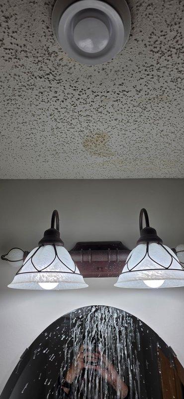 Responded to water stain in powder bathroom ceiling caused by leaking second-floor shower drain. Created access hole in affected ceiling, removed faulty compression-style drain assembly, and installed new two-piece shower drain assembly. Performed testing to verify proper function and resolution of the leak.