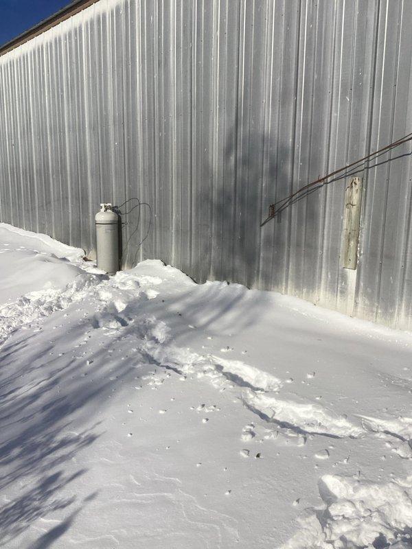 Responded to customer complaint regarding gas burner ignition failure on outdoor wood/gas central boiler system. Diagnostic inspection revealed proper burner starting sequence but insufficient gas pressure. Determined that customer's 100lb LP tank with low-pressure regulator cannot provide adequate pressure through the underground line. Advised customer to upgrade to minimum 250-gallon LP tank with appropriate regulators to resolve the issue.