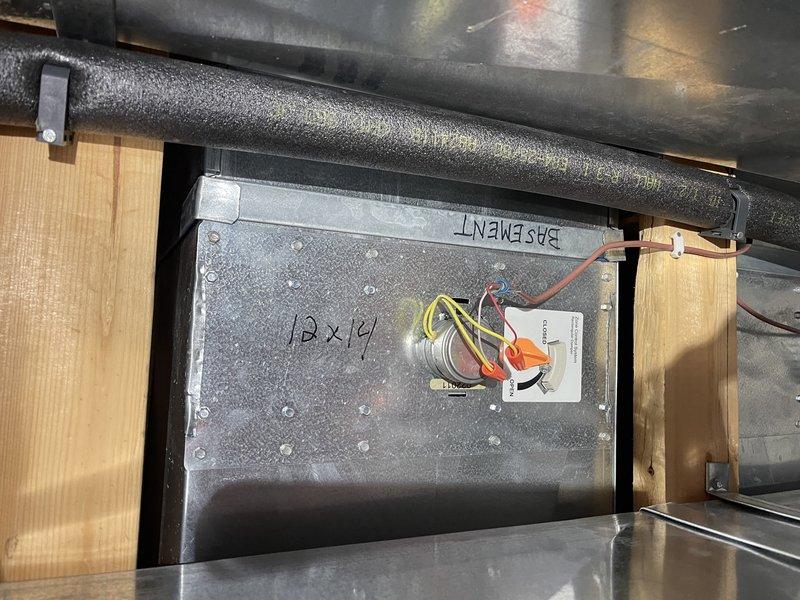 Diagnosed and temporarily resolved overheating issue in basement zone by identifying stuck-open damper. Applied manual lock to damper assembly to prevent further overheating until replacement can be installed. Customer has approved estimate for new zone damper installation.