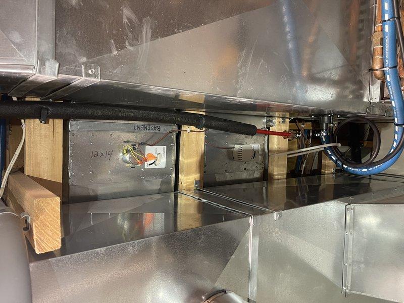 Diagnosed and temporarily resolved overheating issue in basement zone by identifying stuck-open damper. Applied manual lock to damper assembly to prevent further overheating until replacement can be installed. Customer has approved estimate for new zone damper installation.