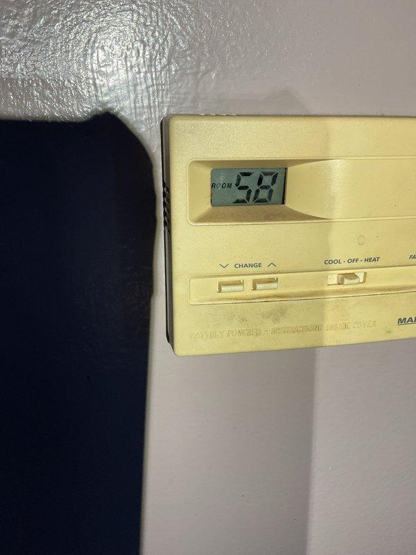 Responded to no heat complaint with furnace showing pressure switch malfunction. Diagnostic revealed locked inducer motor and critical crack in heat exchanger burner face plate. System was tagged out as unsafe to operate due to compromised heat exchanger. Room temperature confirmed at 52°F per thermostat reading. Emergency service arranged for same-day replacement quote.