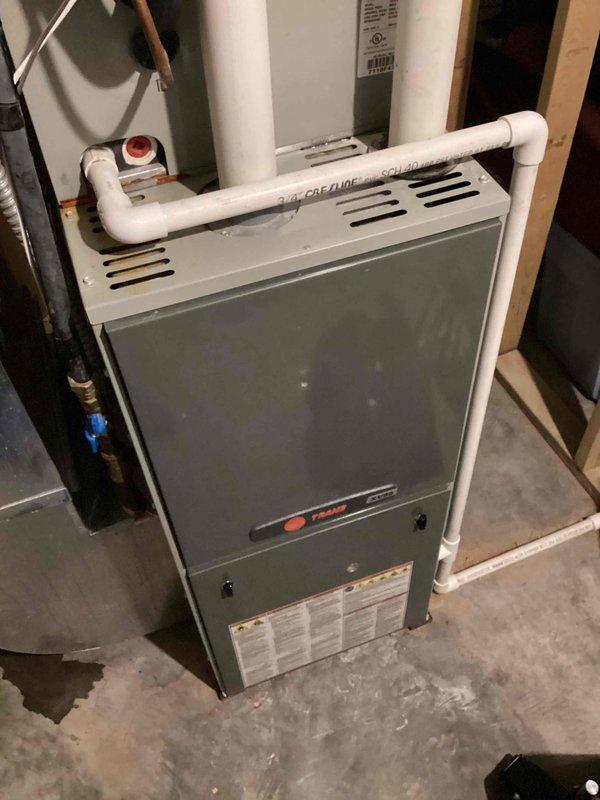 Responded to call for water leakage around Trane furnace with loud banging ductwork during operation. Investigation revealed loose drain line at trap; secured properly with hose clamp. Identified critical heat exchanger failure with cracks at burner inlet and primary heat cell seam. Tagged unit out of service, sourced replacement parts, and verified warranty status for upcoming heat exchanger replacement.