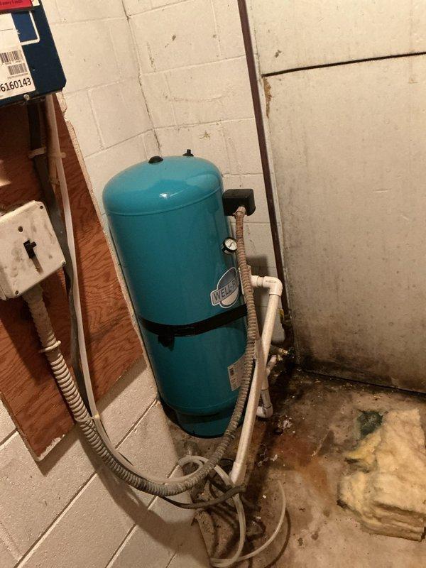 Responded to customer-reported water leak following recent HVAC installation. Conducted comprehensive inspection of basement mechanical room, focusing on water pressure system. Identified minor corrosion at copper fitting connection to pressure gauge showing 30-40 PSI reading on well water pressure tank. Repaired connection point to resolve leak, ensuring proper system pressure and function.