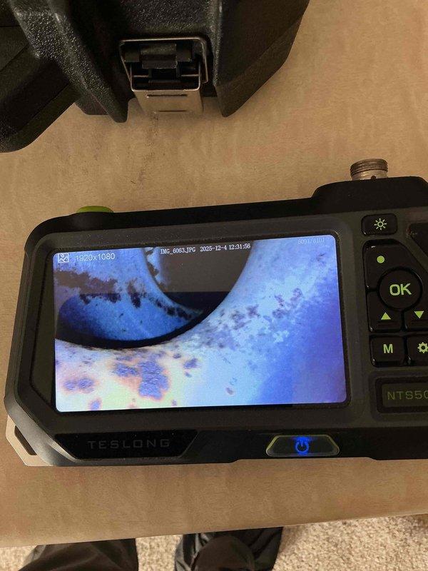 Performed diagnostic service on 22-year-old Skymark furnace with no-heat complaint. Inspection revealed failed control board outputting insufficient voltage (6V) to draft motor relay during heat call. Visual examination using borescope identified significant rust and potential pinholes on heat exchanger, creating unsafe operating conditions. Customer informed that manufacturer is defunct and replacement parts would be difficult to source. Service advisor appointment scheduled to discuss replacement options.