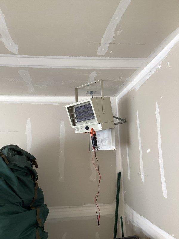 Diagnosed garage heater failure caused by faulty contactor preventing system startup. Inspected fan assembly and housing, noting heavy wear consistent with unit's age (10+ years). Customer was not on premises during service; accessed garage via provided code and documented findings with photos, but no repair was authorized.