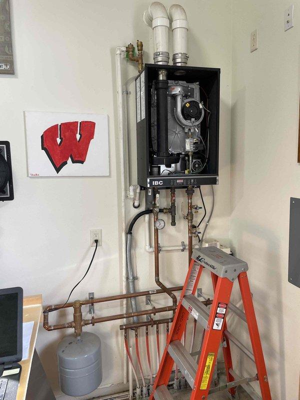 Responded to no-heat call for 9-year-old IBC boiler that failed to ignite. Performed comprehensive cleaning of heat exchanger, flame sensor, spark rod, and condensate trap after diagnosing extensive dirt buildup preventing proper operation. Verified proper function of expansion tank and condensate pump. After service, boiler ignited correctly and heat production was restored. Monitored system for 10 minutes to confirm stable operation.