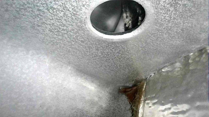 Conducted non-member tune-up service on a relatively new heat pump system with older backup gas heating. Replaced dirty air filter and performed standard preventive maintenance procedures. Observed and photographed system components including drainage port and ceiling vent for documentation purposes.