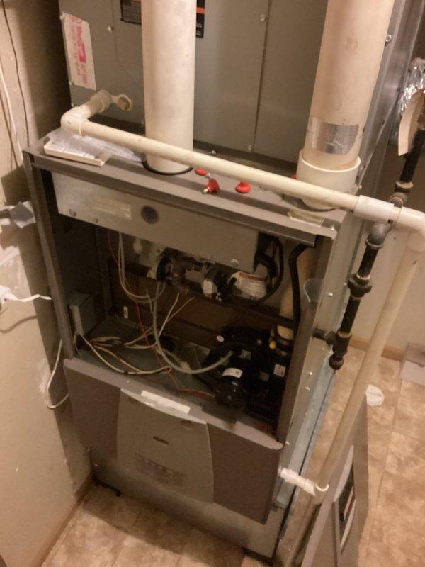 Responded to no-heat complaint at multi-unit residence. Identified two problematic rooms with temperature issues. For NW room, discovered unused baseboard heater and activated it to supplement inadequate airflow. For SE room, inspected furnace operation (functioning properly) but found thermostat set 3° lower than other zones; adjusted setpoint to match building standard. Additionally, observed fresh air damper fully open during blower operation, allowing excessive cold air intake; adjusted damper to 50% capacity to improve overall heating performance and balance.