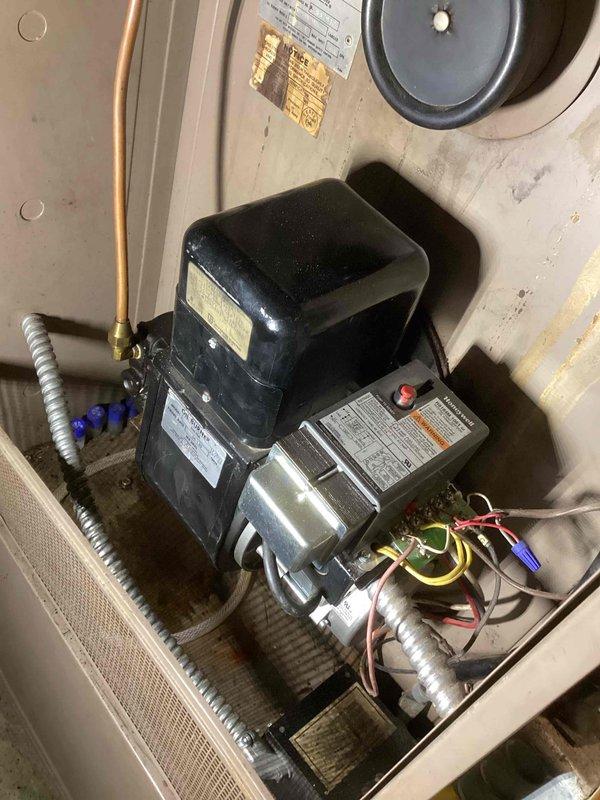 Diagnosed oil furnace failure in non-heating condition. Located Honeywell R8184M primary control module in lockout state. Reset module without success. Upon inspection of oil flow, nozzle, electrodes, and transformer, determined transformer to be malfunctioning. Placed order for replacement transformer to restore heating capability.