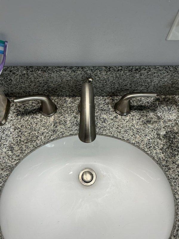 Diagnosed no water flow issue in basement bathroom faucet. Determined cartridges were obstructed by debris despite adequate water supply to fixture. Presented options including warranty replacement, ordering new cartridges, or installing new faucet. Customer elected to replace with new two-handle widespread faucet.