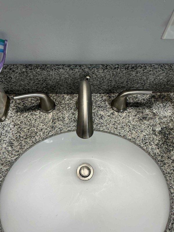 Diagnosed no water flow issue in basement bathroom faucet. Determined cartridges were obstructed by debris despite adequate water supply to fixture. Presented options including warranty replacement, ordering new cartridges, or installing new faucet. Customer elected to replace with new two-handle widespread faucet.