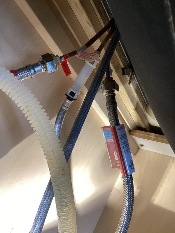 Responded to emergency service call regarding dishwasher leak affecting multiple units. Upon inspection, identified dishwasher failure causing water penetration through ceiling into apartment below. Removed damaged dishwasher to allow area to dry out and inspected under-sink plumbing connections. Also noted additional damage to kitchen sink requiring replacement. Provided estimate for new dishwasher installation and sink/faucet replacement.