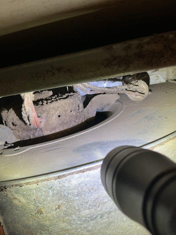 Diagnosed and resolved no-heat issue on 2-year-old furnace in mobile home. Investigation revealed furnace repeatedly clicking but failing to ignite due to a failed blower motor. Removed accumulated dust and debris from system and replaced the defective blower motor, restoring normal heating operation.