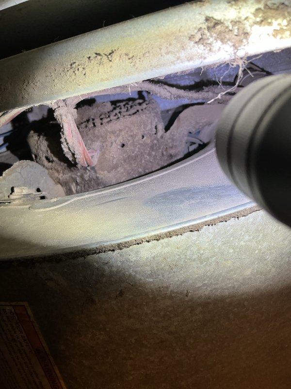Diagnosed and resolved no-heat issue on 2-year-old furnace in mobile home. Investigation revealed furnace repeatedly clicking but failing to ignite due to a failed blower motor. Removed accumulated dust and debris from system and replaced the defective blower motor, restoring normal heating operation.