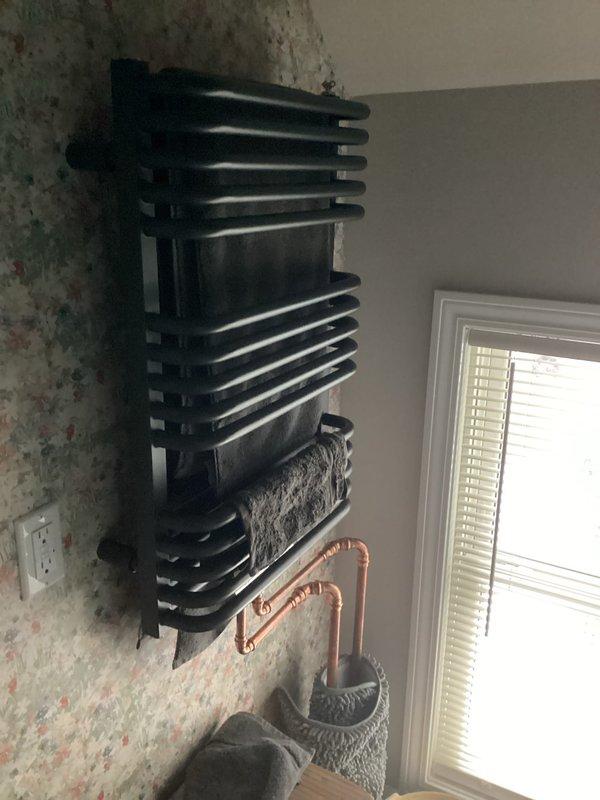 Installed circulator pump to improve flow on non-functional towel warming rack system. Bled air from lines and adjusted system pressure to 20 psi. Verified proper heating operation after modifications were complete.