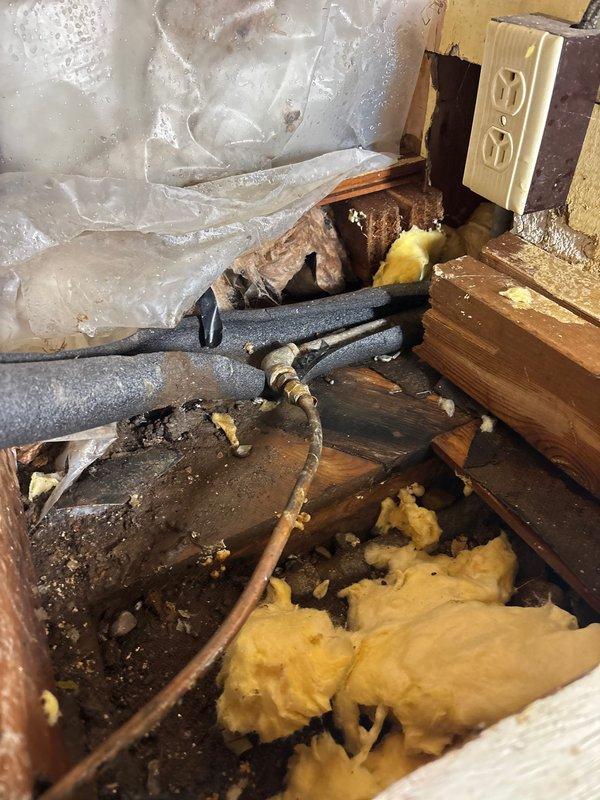 Responded to a water leak emergency at property where a hot water supply line to the kitchen faucet had ruptured. Accessed the affected plumbing system under the kitchen sink, identified the burst line, and replaced the damaged kitchen faucet supply line, successfully resolving the leak.