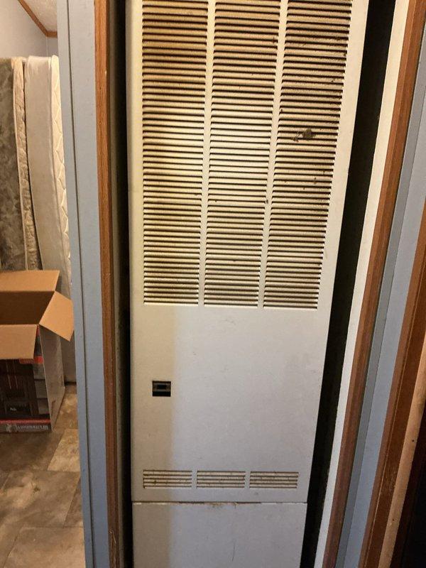 Responded to no heat complaint on 5-year-old Goodman furnace. Diagnostic inspection revealed furnace attempting to ignite (clicking) but failing to maintain flame. Identified corroded flame sensor and signs of rust in cabinet, though no active leaks were present. Successfully replaced flame sensor, restoring normal heating function.