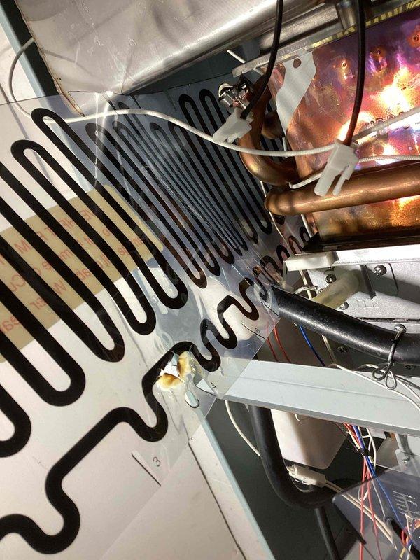 Performed descaling and maintenance service on tankless water heater system due to no hot water complaint. Replaced damaged components including coil and ignitor, and completed system descaling. Identified faulty overheat film wrap with no continuity during diagnostics; ordered replacement parts and scheduled return visit for final repair completion.