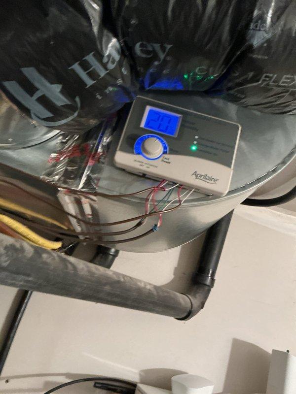 Diagnosed intermittent humidifier operation issue previously reported on 12/4. Reconfigured Aprilaire humidifier control settings to operate only when furnace is in heating mode with blower fan running. Verified proper functionality of digital humidity control panel displaying 24% relative humidity with active status indicator illuminated.