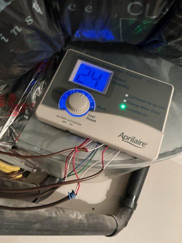 Diagnosed intermittent humidifier operation issue previously reported on 12/4. Reconfigured Aprilaire humidifier control settings to operate only when furnace is in heating mode with blower fan running. Verified proper functionality of digital humidity control panel displaying 24% relative humidity with active status indicator illuminated.
