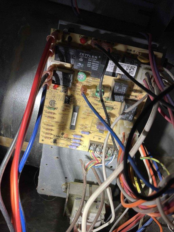 Diagnosed inoperative furnace showing inducer operation but unlit status lights. Found control board relay was buzzing loudly with failing contacts. Temporarily restored operation by tapping relays, but recommended replacement of the control board due to faulty relay. Customer informed that system replacement would be more cost-effective given the unit's age (15 years) and recent repair history. Photos documented the Emerson circuit board with failing Zettler relays and burner assembly inspection.