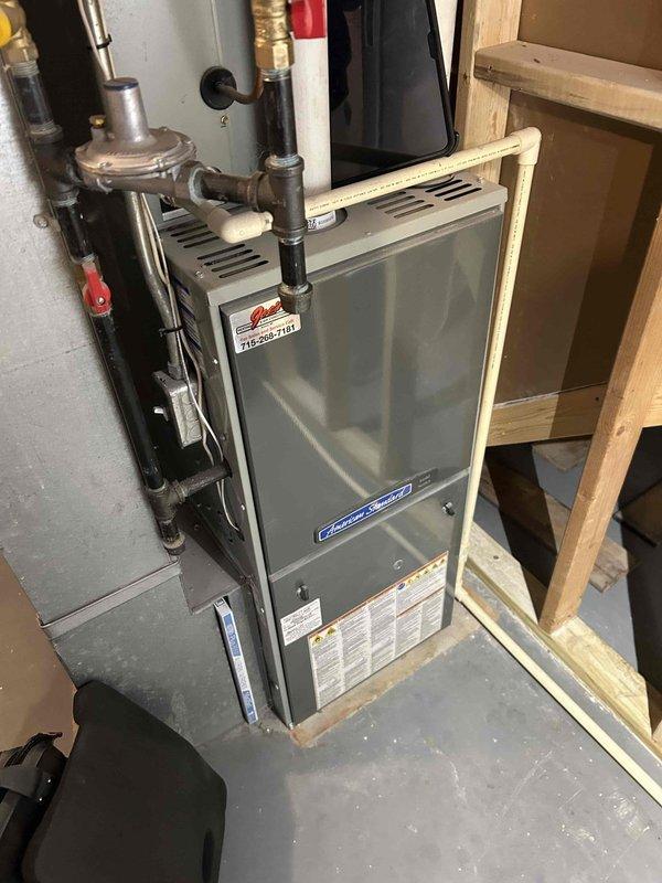 Performed complimentary furnace tune-up on 6-7 year old LP system. Discovered cracked heat exchanger that failed crimp test. Carbon monoxide levels measured at 8 ppm. Service included cleaning flame sensor, clearing debris from pressure switch and condensation trap, verifying proper LP gas valve pressure, and installing carbon monoxide detector. Recommended regular air filter changes. Homeowner informed of heat exchanger issue.