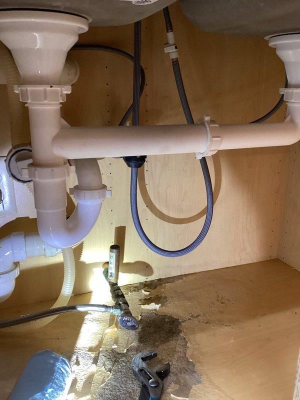 Completed installation of plumbing connections for newly installed double sink and cabinets. Installed new shut-off valves and connected water supply lines. Properly connected sink drains to existing PVC branch line using P-traps and horizontal connector pipes, ensuring proper drainage and sealed connections.