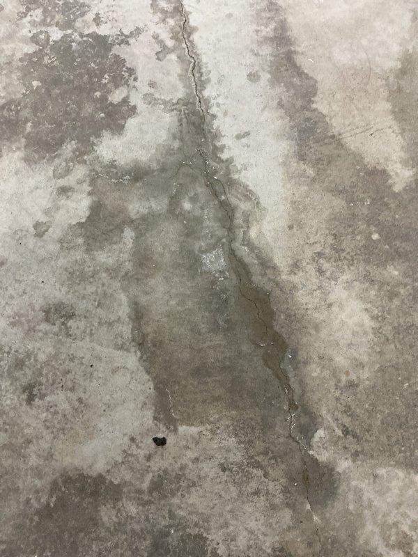 Conducted warranty inspection of in-floor heating system installed in March. Documented structural issues including significant concrete cracking and pipe damage in the recreation room. Multiple photos taken showing vertical fractures in the concrete with visible moisture damage and discoloration around affected areas. Scheduled service advisor for further assessment.