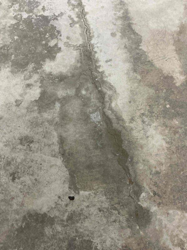 Conducted warranty inspection of in-floor heating system installed in March. Documented structural issues including significant concrete cracking and pipe damage in the recreation room. Multiple photos taken showing vertical fractures in the concrete with visible moisture damage and discoloration around affected areas. Scheduled service advisor for further assessment.