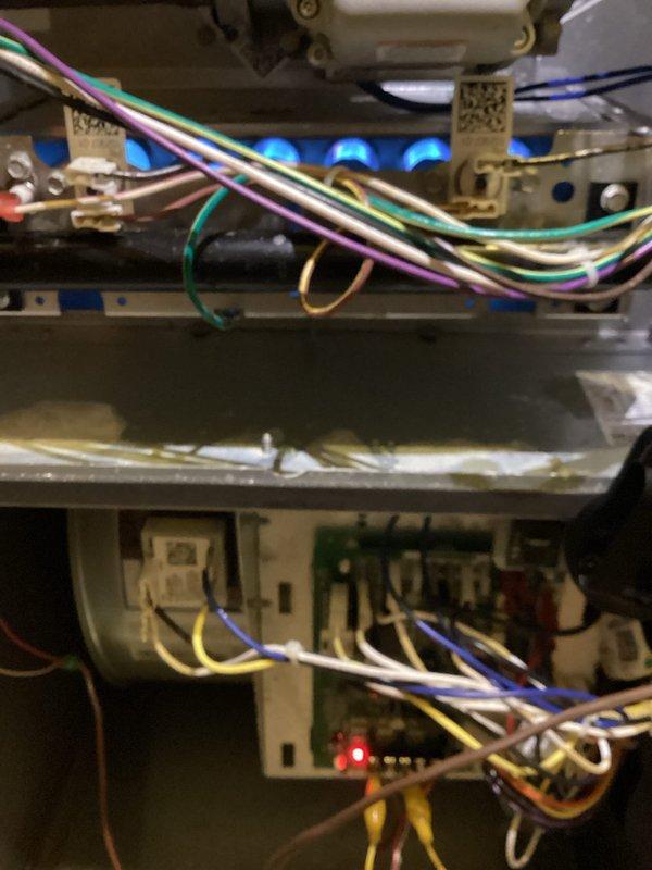 Responded to no heat service call for 12-year-old furnace. Homeowner reported clicking noise and flashing red light. Diagnostic inspection revealed normal system operation - red indicator light is standard during heating cycle as verified by flame sensor activation. Inspected gas connections and confirmed no leaks present. Explained to customer that elevated temperature in furnace room is due to supply vent placement directly above unit. No repairs necessary; system functioning properly as installed last year.