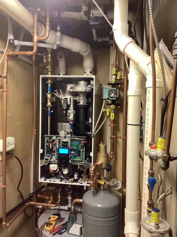 Resolved heating issues by correcting improperly wired pump board and reconfiguring boiler parameters with tech support guidance. Rewired recirculation pump to connect directly to boiler instead of outlet for proper control functionality. Changed thermostat to compatibility setting #3 on control board to enable floor heating zone operation. All systems now functioning correctly with proper recirculation pump setup.