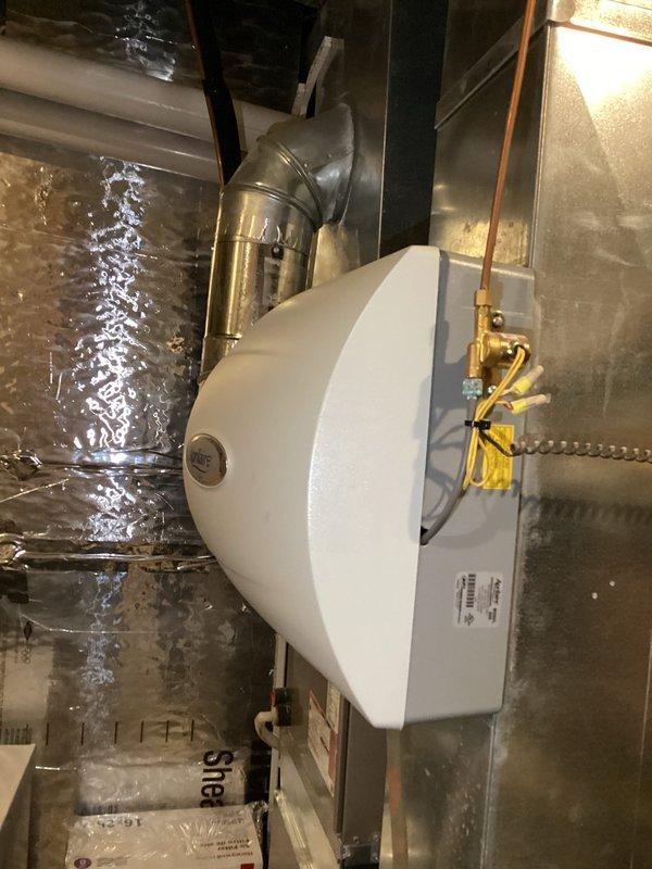 Responded to service call for non-functioning Aprilaire whole-home humidifier. Diagnostic testing revealed E1 error code indicating control board or humidity sensor issue. Upon inspection, discovered humidity sensor was heavily coated with dust, impeding proper function. Thoroughly cleaned sensor, reset unit, and performed operational test. Humidifier restored to proper working condition. Customer advised of potential need for control board replacement if issue recurs.