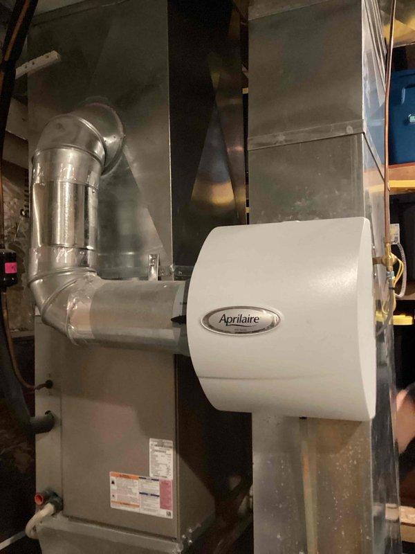 Responded to service call for non-functioning Aprilaire whole-home humidifier. Diagnostic testing revealed E1 error code indicating control board or humidity sensor issue. Upon inspection, discovered humidity sensor was heavily coated with dust, impeding proper function. Thoroughly cleaned sensor, reset unit, and performed operational test. Humidifier restored to proper working condition. Customer advised of potential need for control board replacement if issue recurs.