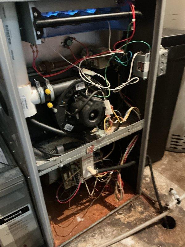 Performed diagnostic inspection on aged furnace experiencing cycling issues approximately every 15 minutes due to airflow restrictions. Interior inspection revealed significant debris accumulation in the compartment and potential issues with the blower motor assembly. Recommended system maintenance to address dirt buildup and discussed monthly maintenance package options with customer. Referred to comfort advisor for evaluation of replacement options given the unit's age and condition.