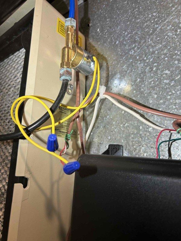 Diagnosed non-operational humidifier on previously installed HVAC system. Verified 24V power supply to solenoid using Fluke 365 True RMS Clamp Meter and confirmed solenoid resistance at 35.5 ohms. Observed intermittent clicking of faulty solenoid that remained in closed position despite proper voltage. Replaced defective solenoid to restore proper humidifier function.