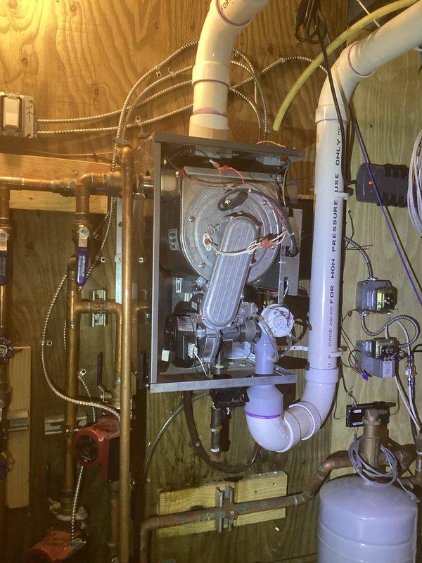 Responded to service call for boiler malfunction resulting in no hot water; diagnosed pressure switch code error. Upon removing the cover, system became operational, but identified failing bearing in combustion fan motor causing abnormal noise. Submitted parts request for replacement fan motor as current unit appears to have temporarily locked up but is functioning inconsistently.