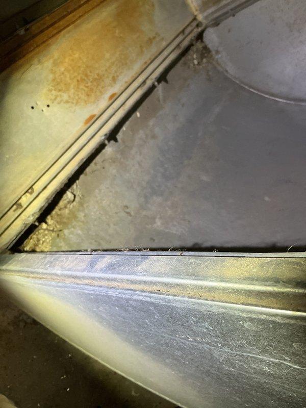 Performed standard furnace tune-up on 23-year-old LP system. Unit is operational but showing significant age-related wear with visible corrosion and buildup inside cabinet. Noted non-functional humidifier and customer's regular flame sensor maintenance. Inspected and verified filter condition, which appeared relatively clean. Recommended comfort advisor consultation and humidifier replacement options.